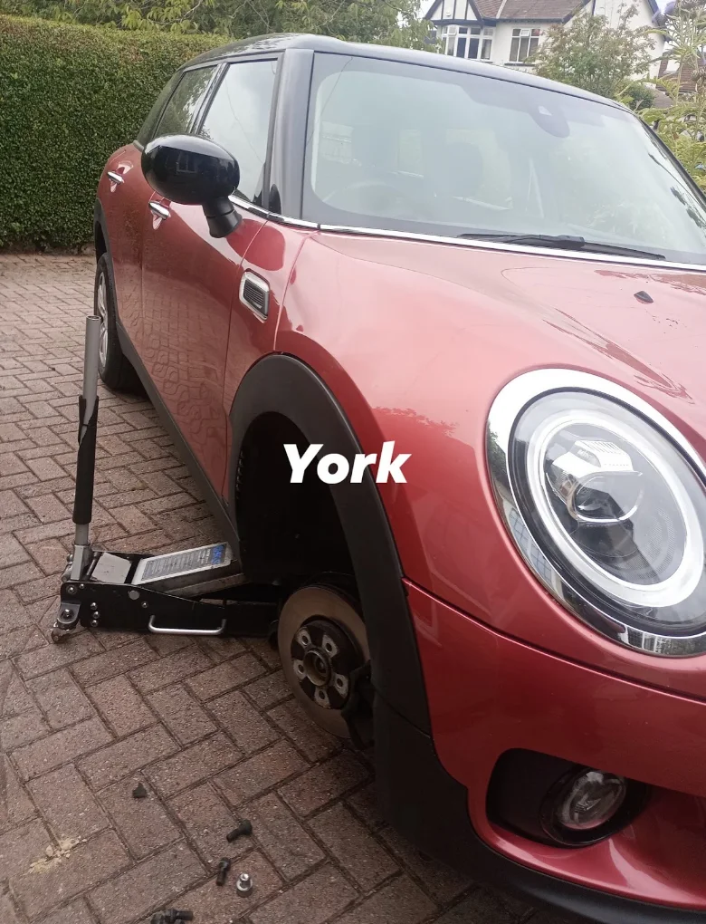 Mobile tyre fitting on a red Mini in York