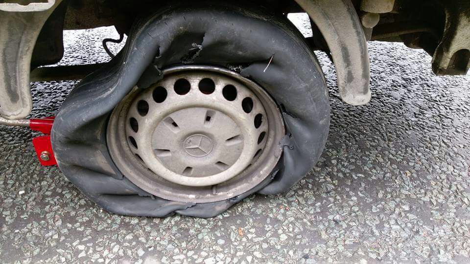 Severely damaged flat tyre on a vehicle